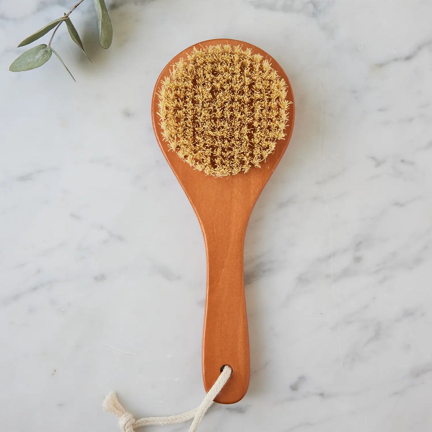 Juniper Loft Soap Company sisal back scrubber on a gray marble countertop