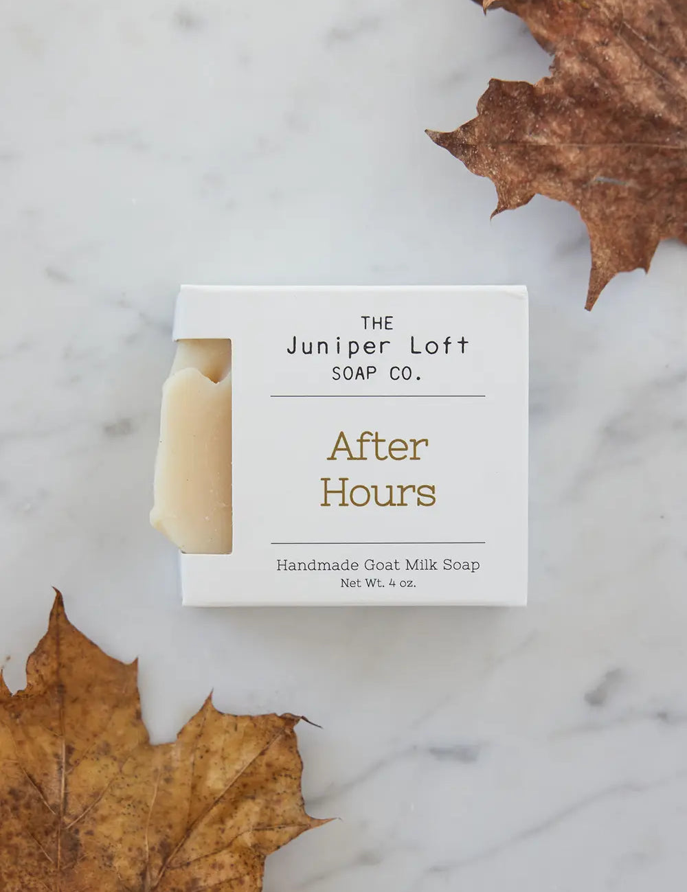 Bar of After Hours soap from Juniper Loft Soap Company next to two large brown fall leaves