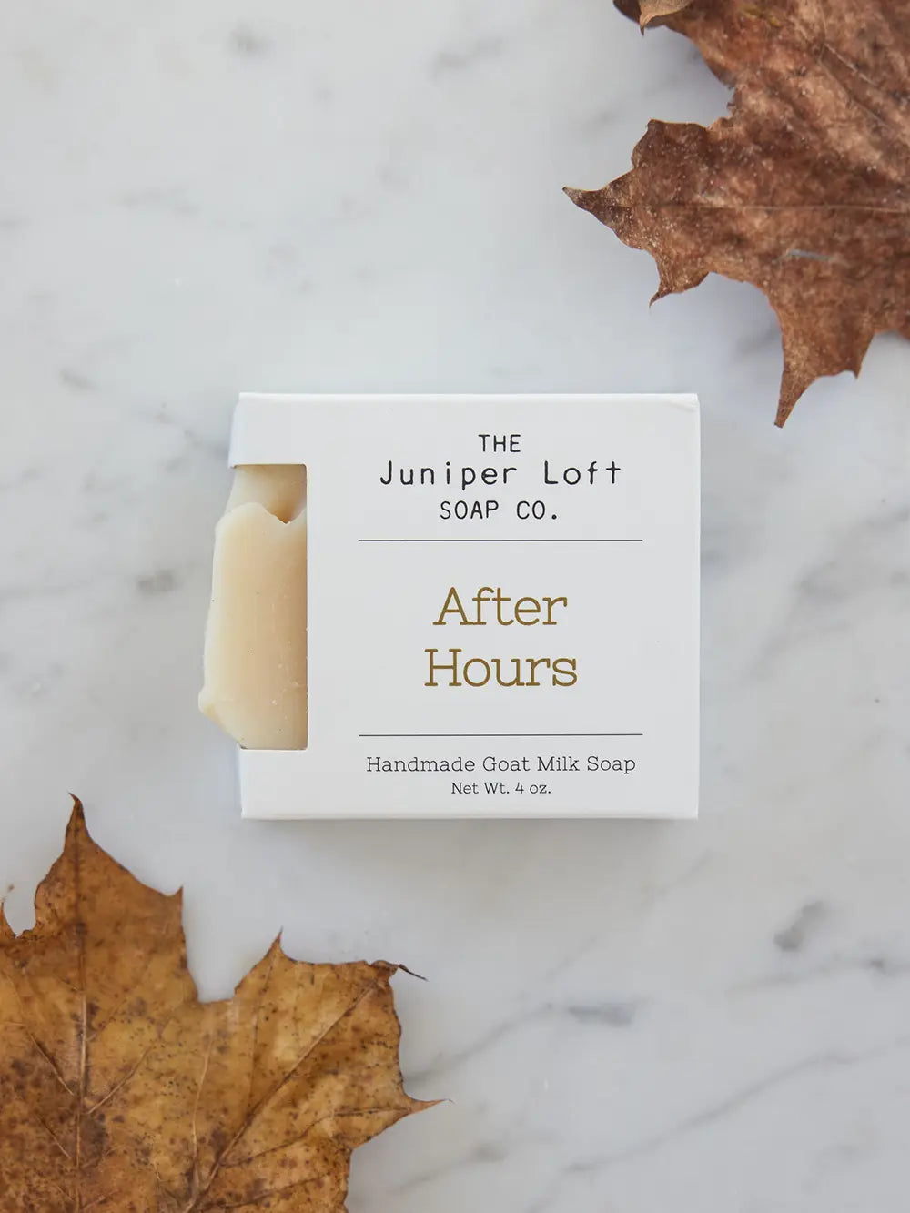 Bar of After Hours soap from Juniper Loft Soap Company next to two large brown fall leaves