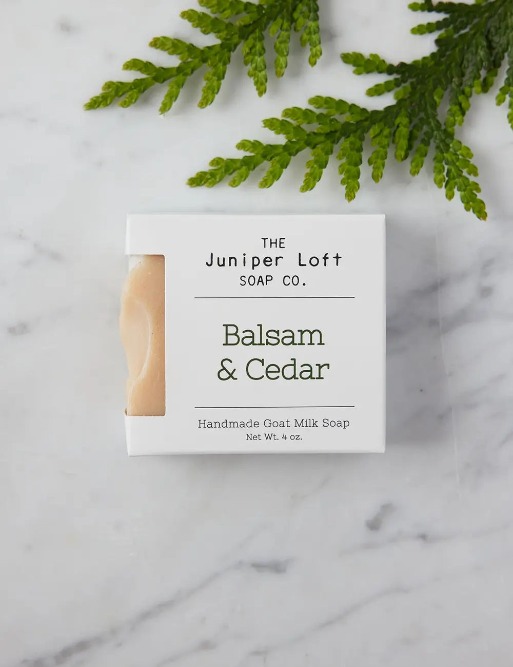 Bar of Balsam and Cedar soap from Juniper Loft Soap Company with a small brand of cedar needles