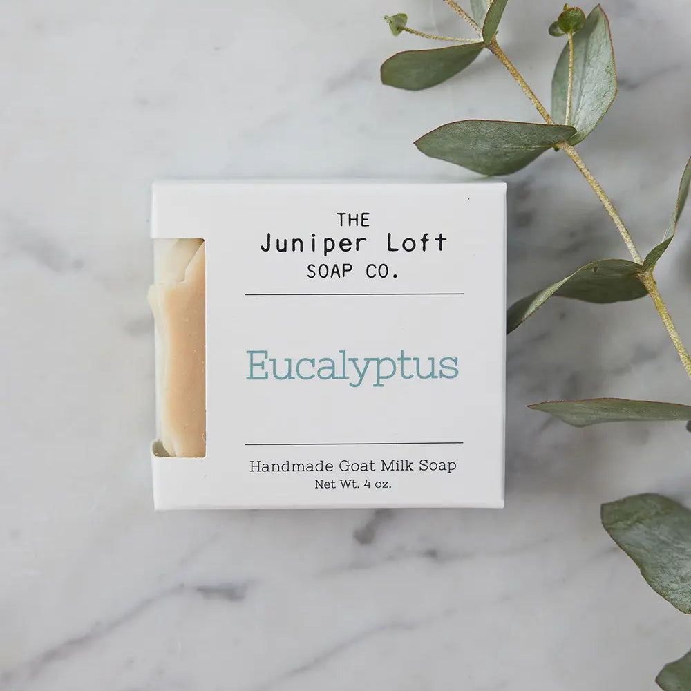 Bar of Eucalyptus soap from Juniper Loft Soap Company with a long stem of eucalyptus
