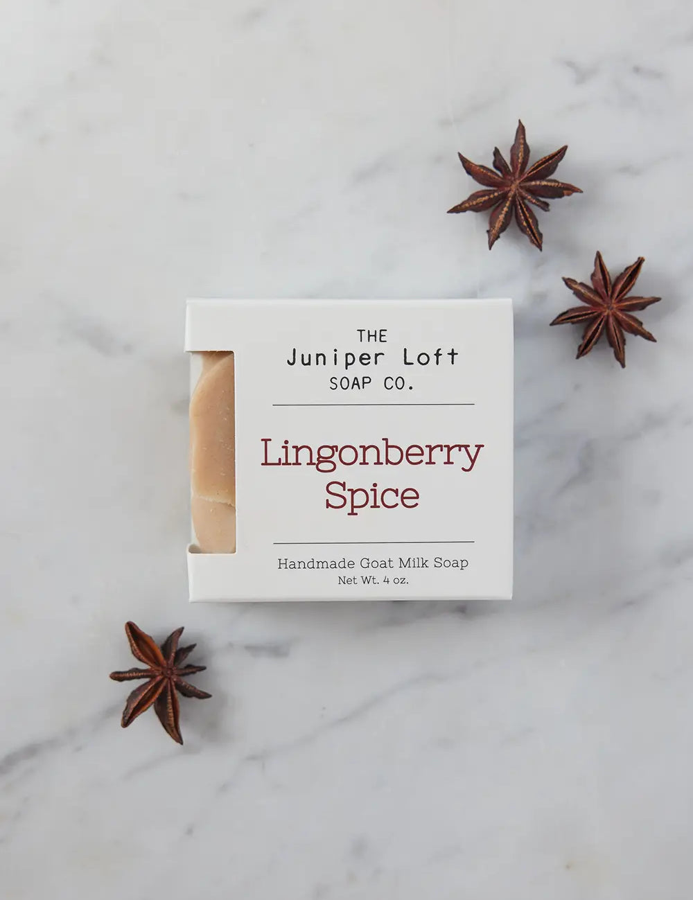 Bar of Lingonberry Spice soap from Juniper Loft Soap Company surrounded by a few star anise