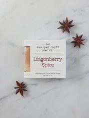 Bar of Lingonberry Spice soap from Juniper Loft Soap Company surrounded by a few star anise