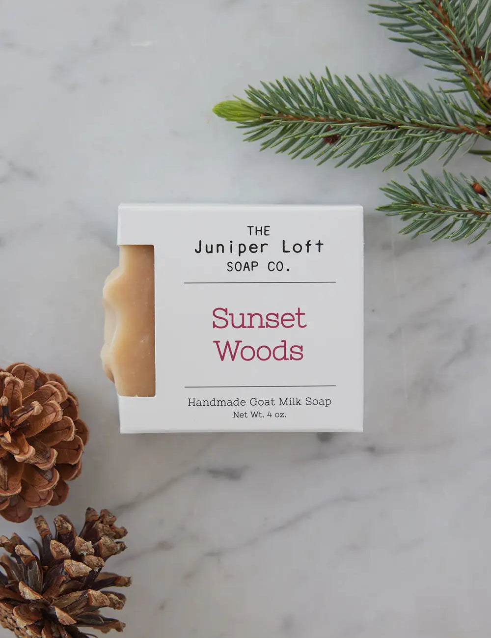 Bar of Sunset Woods soap from Juniper Loft Soap Company surrounded by pine needles and cones
