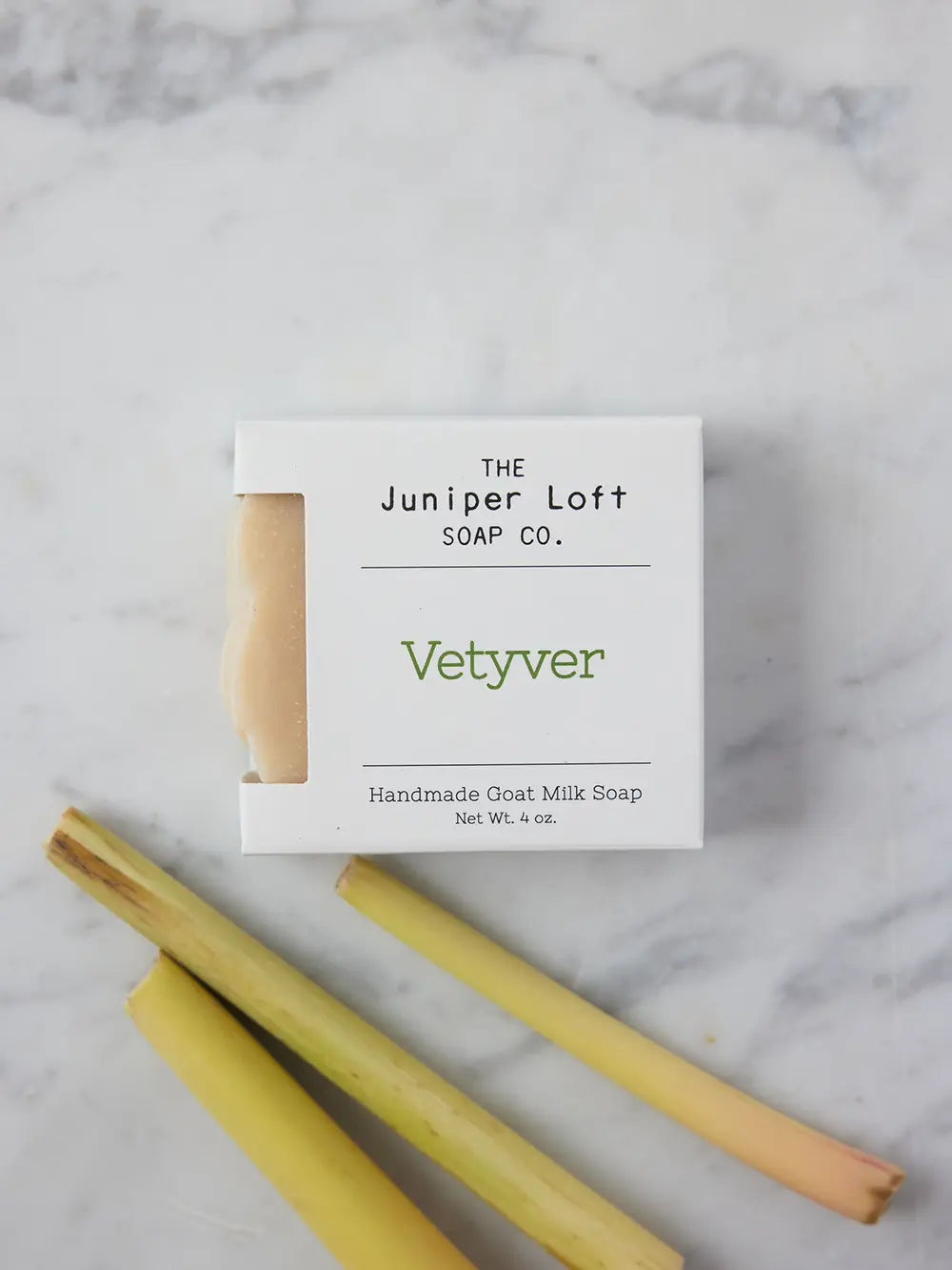 Bar of Vetyver soap from Juniper Loft Soap Company next to three slips of vetyver