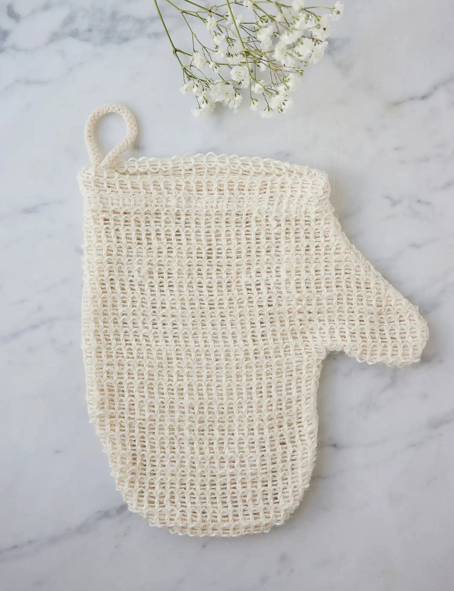 Sisal mitt from Juniper Loft Soap Company on a gray marble countertop