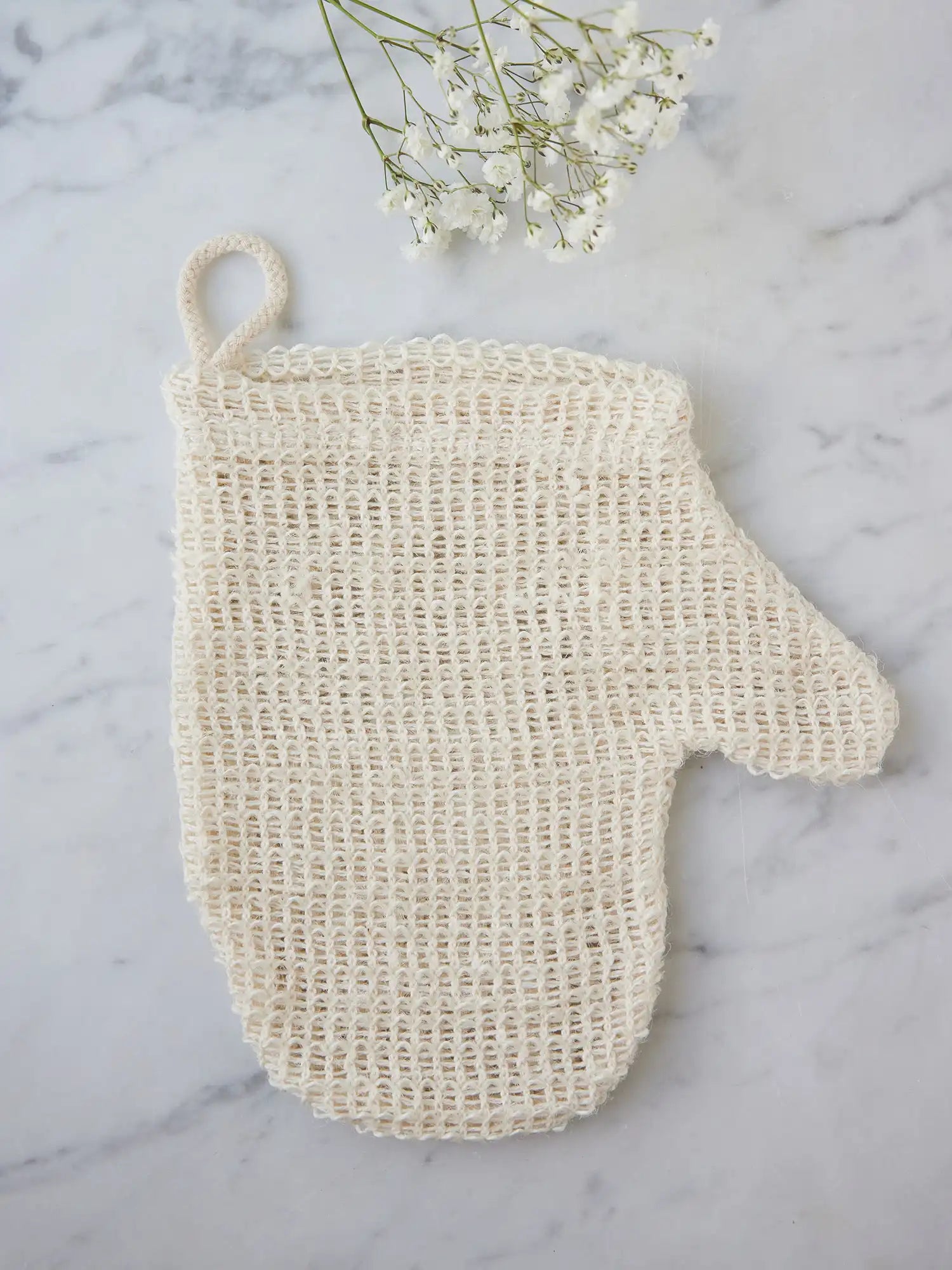 Sisal mitt from Juniper Loft Soap Company on a gray marble countertop
