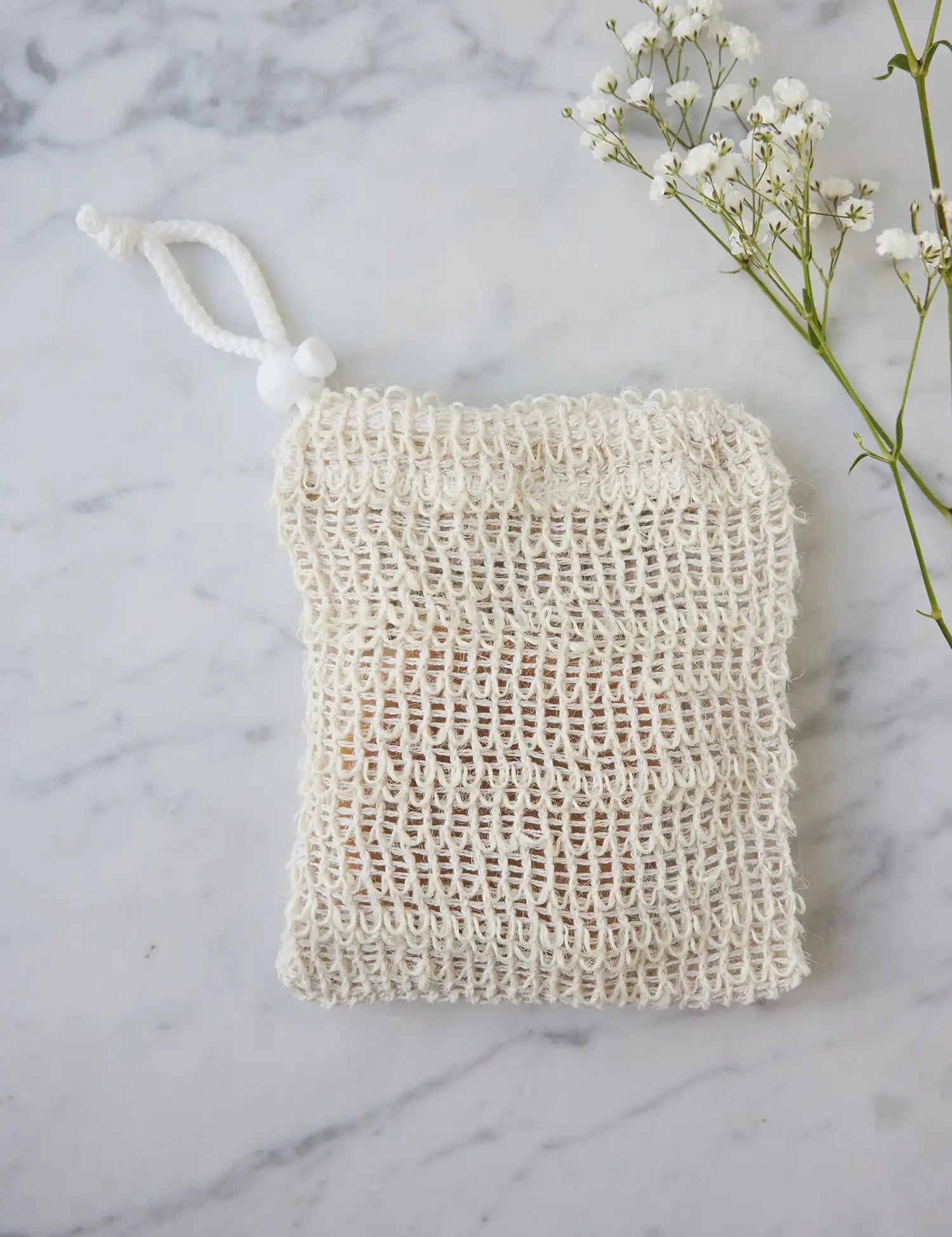 Sisal pouch from Juniper Loft Soap Company on a gray marble countertop