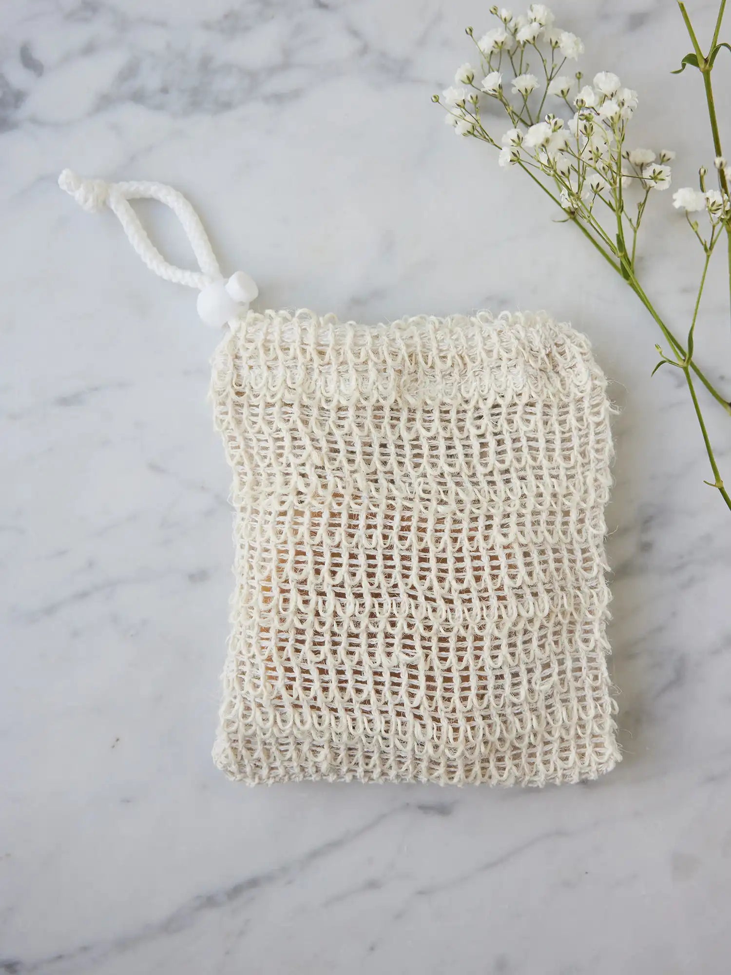 Sisal pouch from Juniper Loft Soap Company on a gray marble countertop