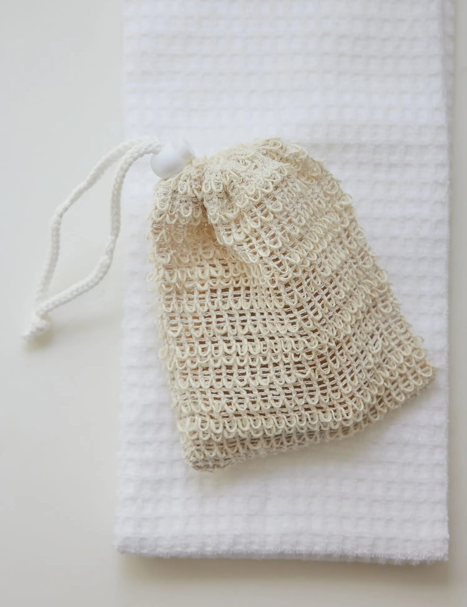 Sisal pouch from Juniper Loft Soap Company on a white towel