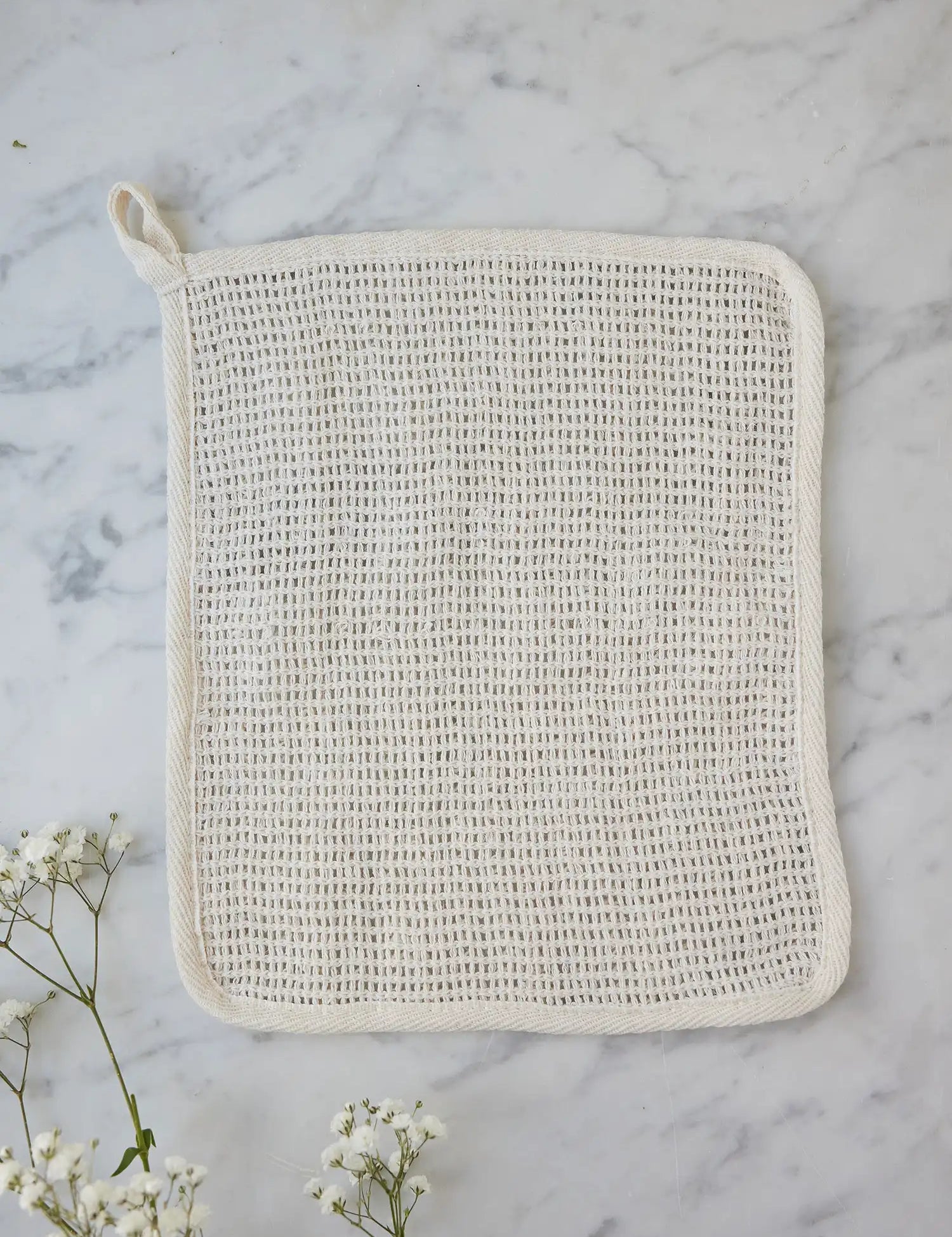 Sisal washcloth from Juniper Loft Soap Company on a gray marble countertop