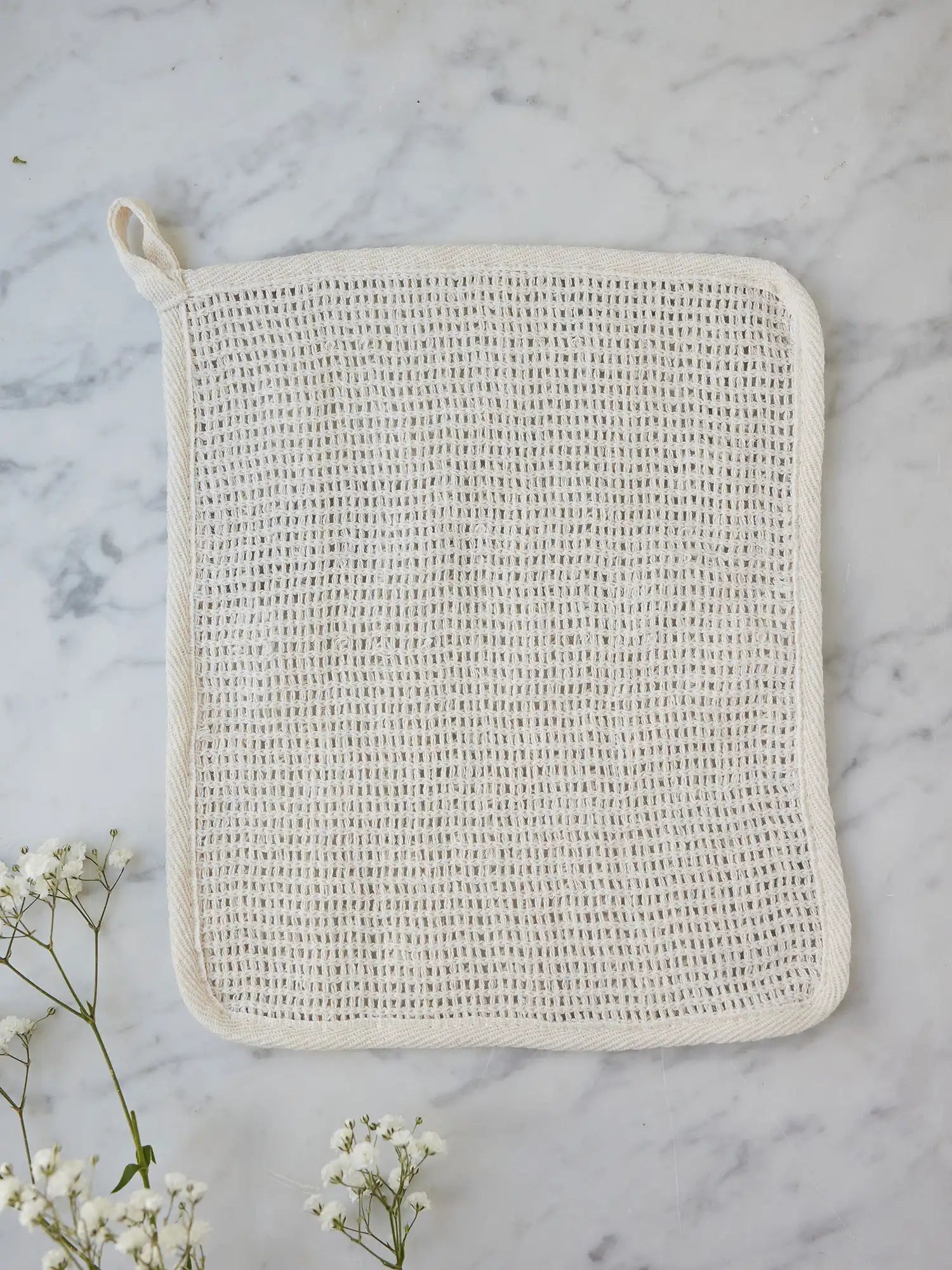 Sisal washcloth from Juniper Loft Soap Company on a gray marble countertop