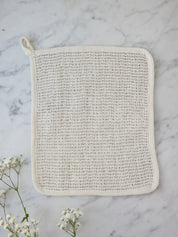 Sisal washcloth from Juniper Loft Soap Company on a gray marble countertop